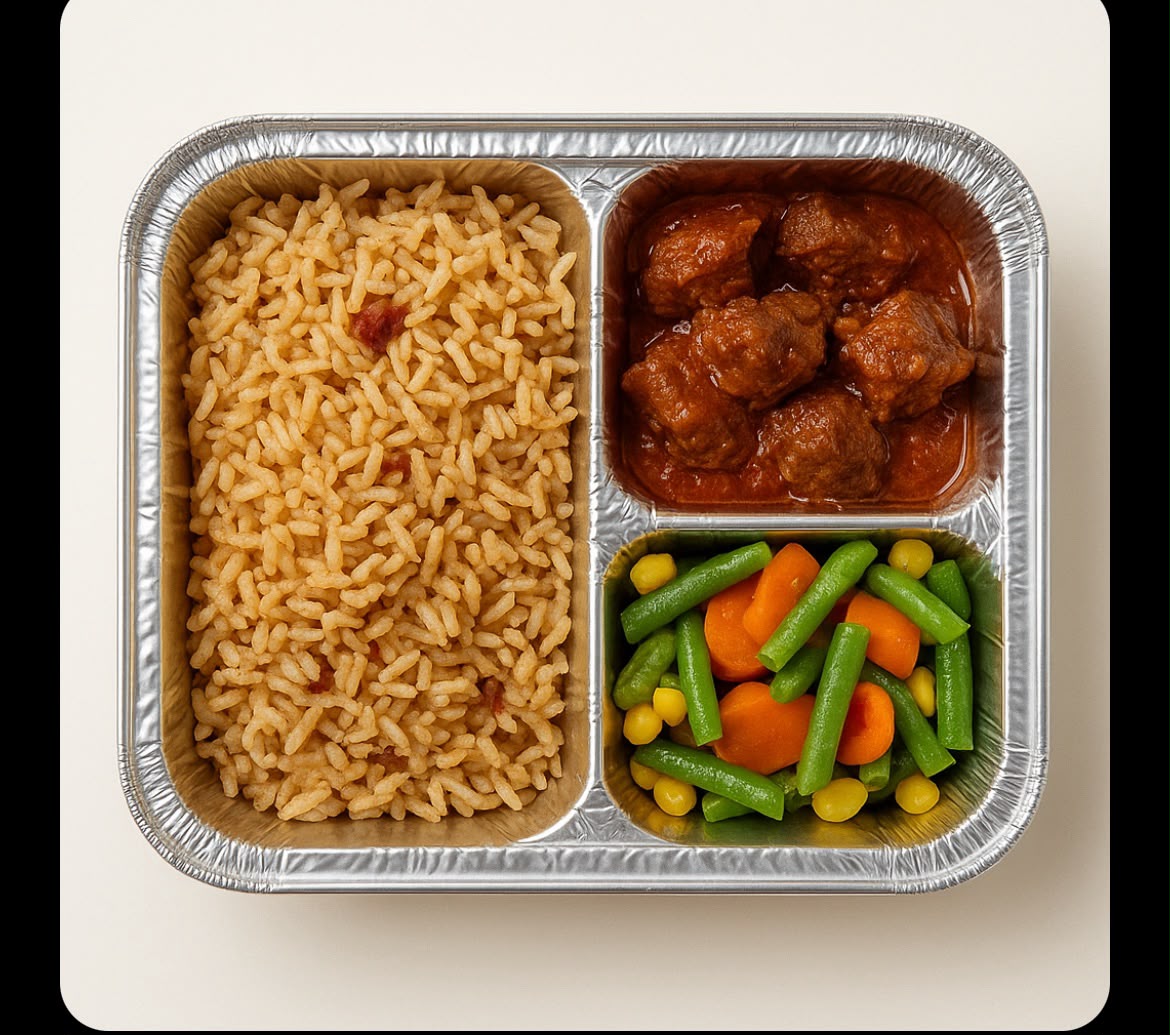 Individual packaged meal with jollof rice, stew and vegetables